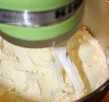 Creaming butter  to help make cream-cheese frosting