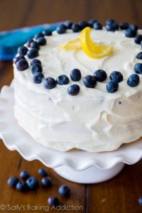 Deliciously sweet and light Lemon Blueberry Layer Cake. Tangy cream cheese frosting gives each bite a sweet touch!