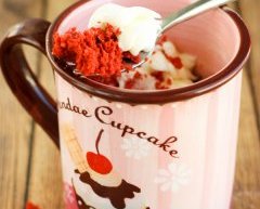 Moist gluten-free red velvet mug cake with sweet cream cheese frosting. It takes just minutes to make in the microwave!