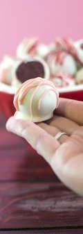 Red Velvet Cake Balls - these delicious small morsels are just like bites of red velvet dessert rolled up-and dipped in white chocolate. Perfect treat for valentine's day.