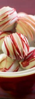 Red Velvet Cake Balls - these delicious small morsels are just like bites of red velvet dessert rolled up-and dipped in white chocolate. Perfect treat for romantic days celebration.